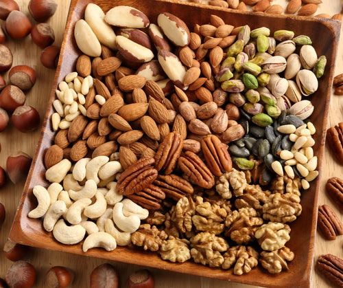 Amazin’ Graze assorted nuts arranged in a wooden tray for a festive National Day snack board.