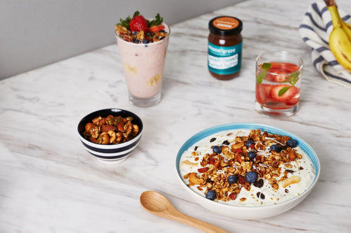 Amazin’ Graze breakfast spread with granola bowl, nut mix, smoothie, almond butter, and fruit water.