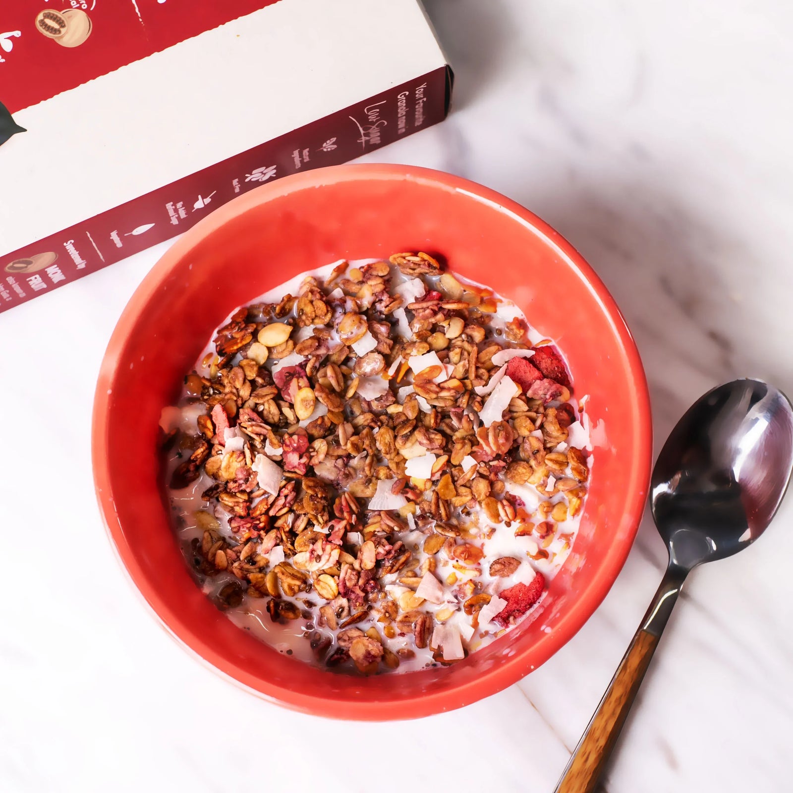 Amazin’ Graze granola served with milk in a red bowl for a balanced breakfast.