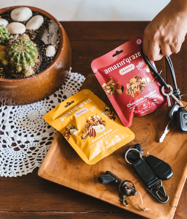 Amazin’ Graze Banana Bread and Chocolate Hazelnut Granola Bites beside keys for busy mornings.
