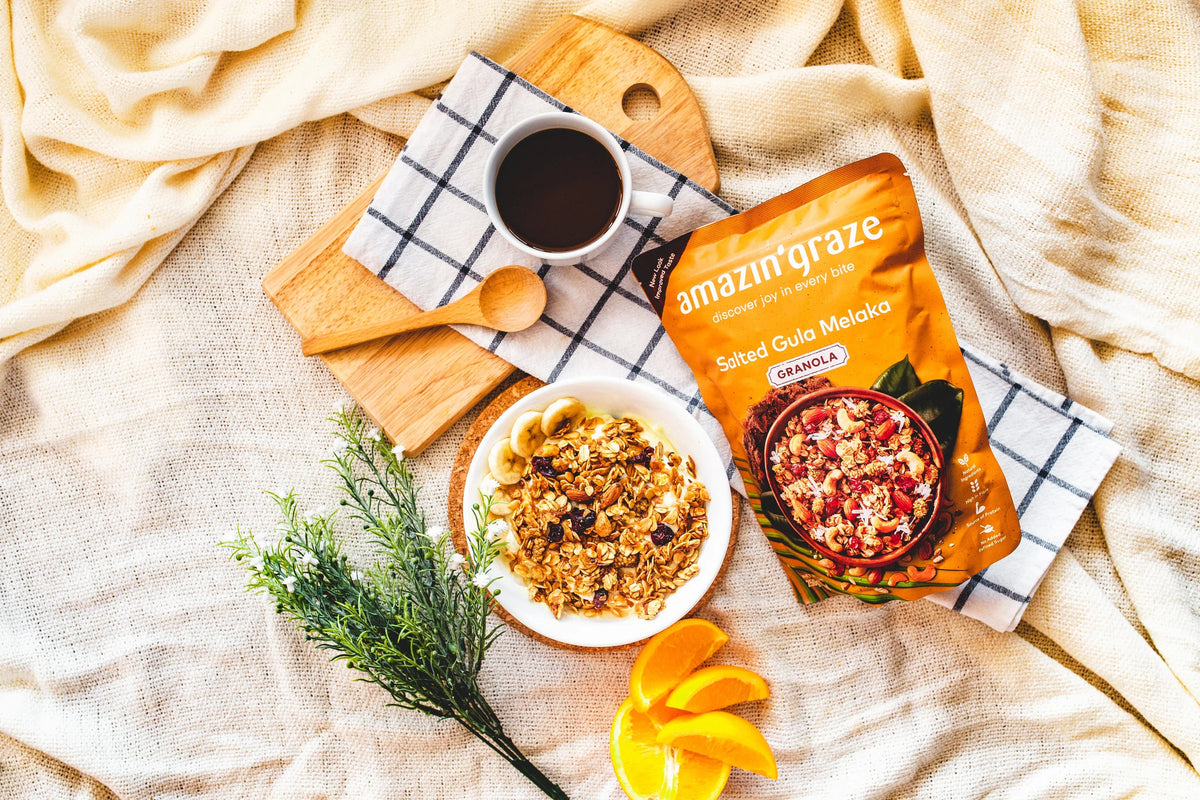 Healthy breakfast spread featuring oats, granola, nuts, seeds, and fresh fruit arranged on a bright kitchen table.