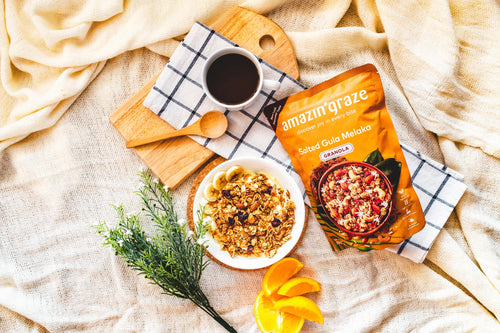 Healthy breakfast spread featuring oats, granola, nuts, seeds, and fresh fruit arranged on a bright kitchen table.