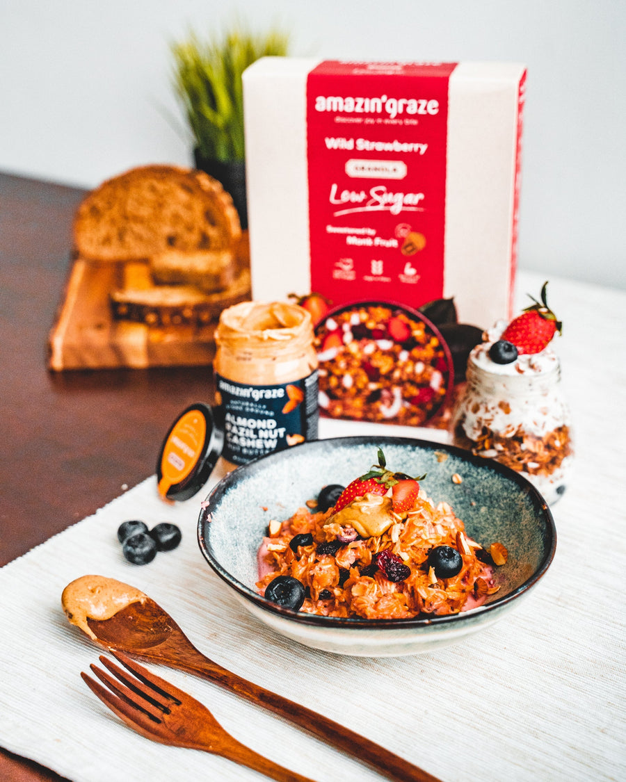 Amazin’ Graze Low Sugar Wild Strawberry Granola with almond butter, berries, toast, and breakfast bowl.